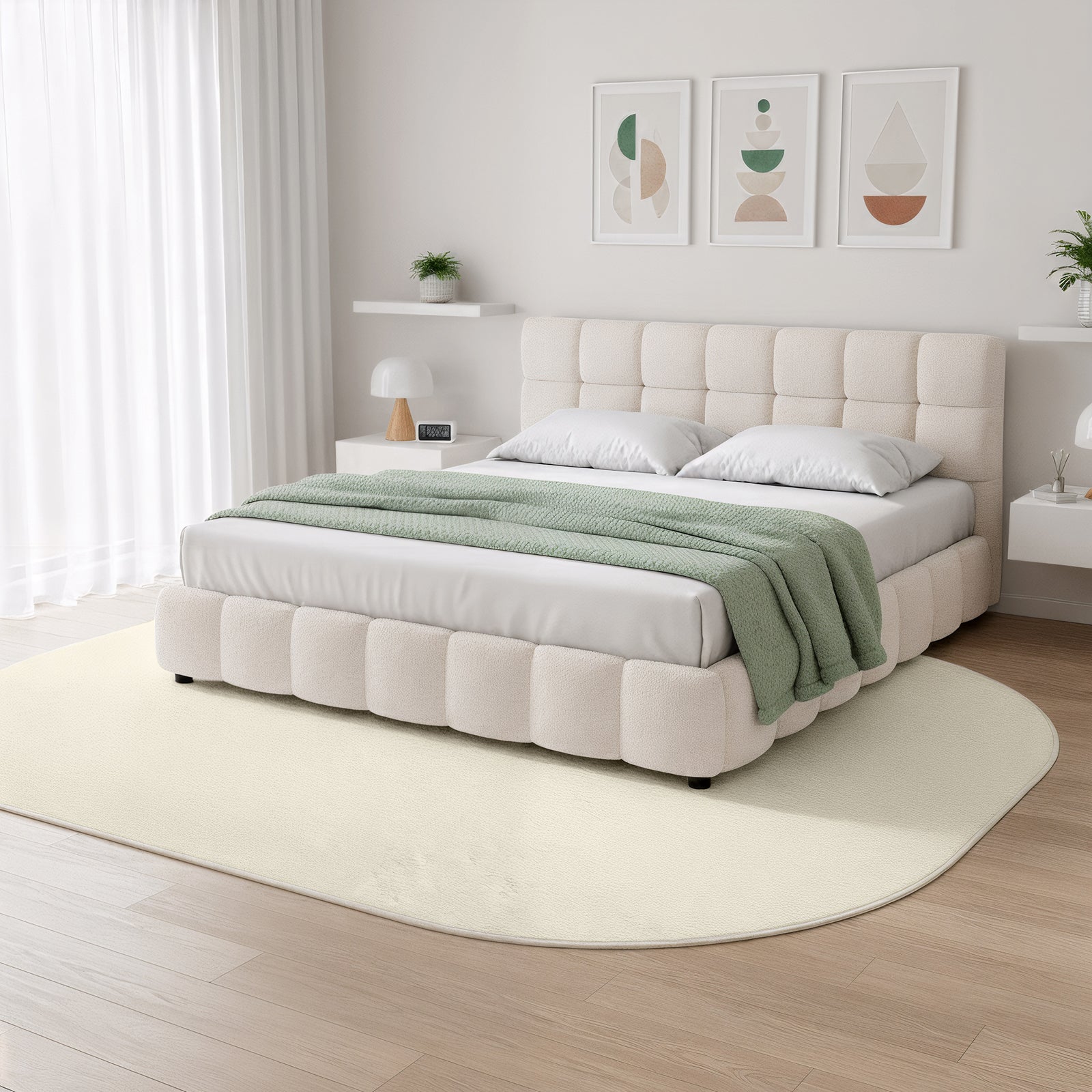 Pavla 240 x 330cm Oval Soft Rug in Beige beneath the bed, showcasing its plush texture and elegant oval shape, complements the minimalist bedroom’s neutral tones and modern aesthetic.