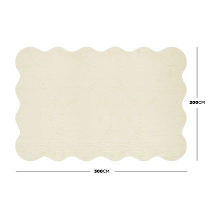 Pixie 200x300cm Large Wavy Shag Rug in Beige features a cream-colored surface with scalloped edges, offering a plush, wool-like texture and durable construction for stylish, comfortable living spaces.