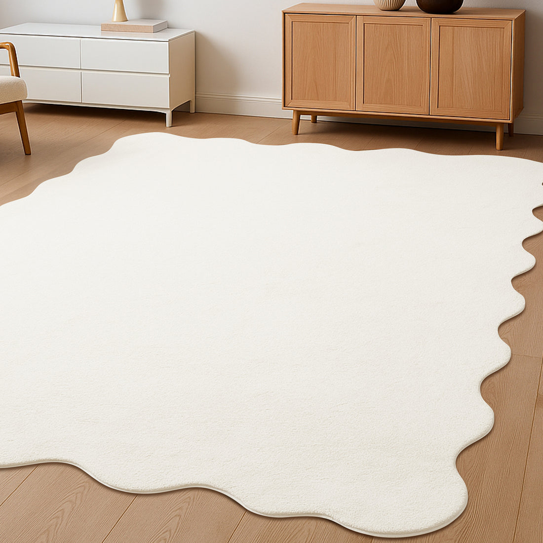 Pixie 200x300cm Large Wavy Shag Rug in Cream White, with an organic shape on a light wood floor, beneath a low white cabinet and mid-century-style sideboard, adding plush texture and elegance.