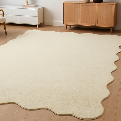 Pixie 300x400cm Large Wavy Shaggy Rug in Beige, softly textured with a wavy edge, laid on a wood floor, surrounded by minimalist furniture, enhancing a modern living room's cozy appeal.