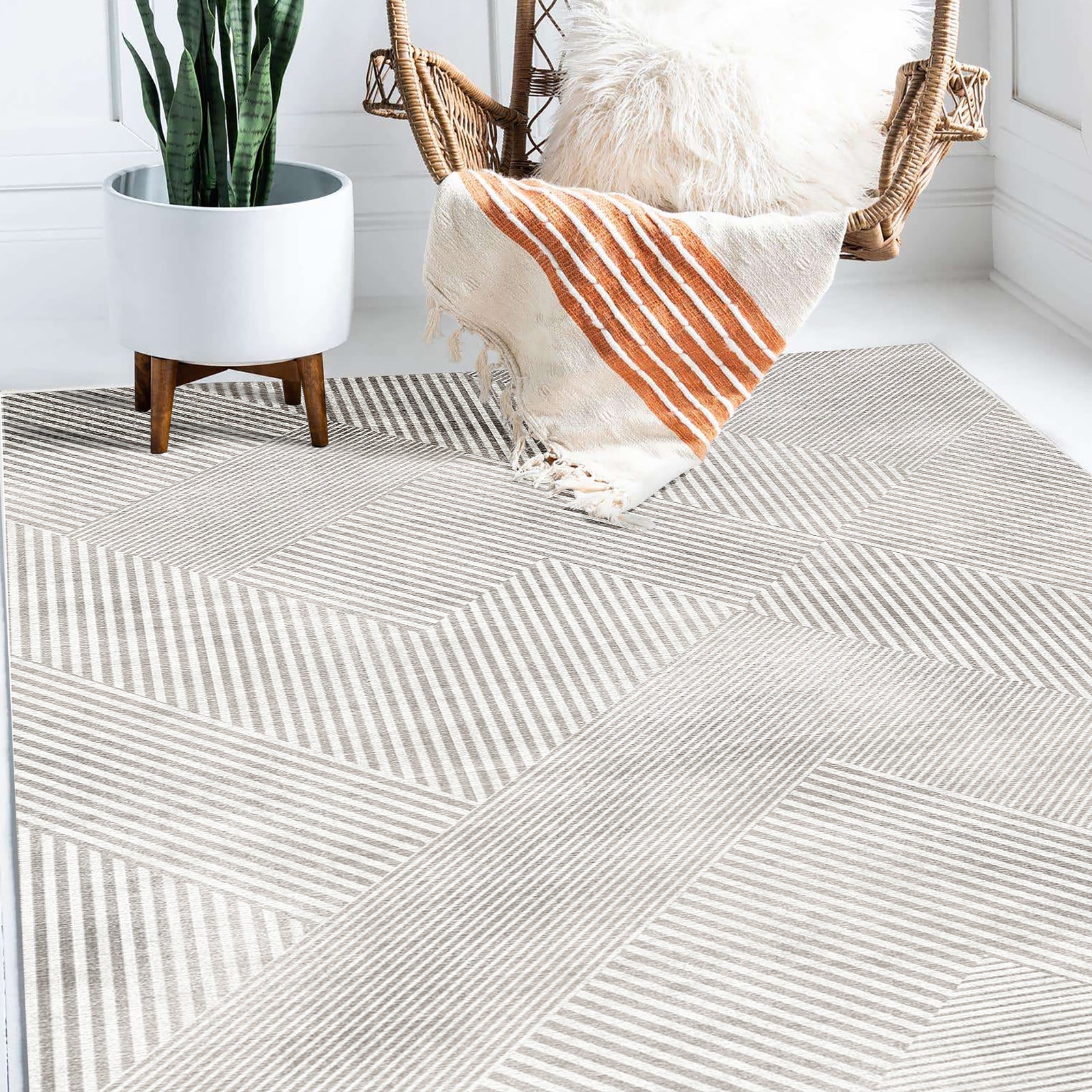 Rosson 200x300cm Large Modern Abstract Indoor Rug with a bold geometric pattern under a rattan swing chair, enhancing the room's airy and minimalist decor.
