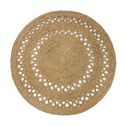Sandra Brown Seagrass Rug 180cm features a round, braided design with a concentric weave and looped braiding, crafted from natural fibers, highlighting its intricate detailing and versatile style.