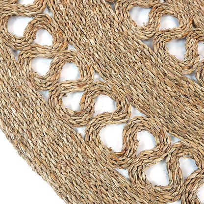 Close-up of Sandra Brown Seagrass Rug 180cm, showcasing intricate concentric braided design with open circular loops, highlighting its natural-fiber craftsmanship ideal for minimalist and modern interiors.