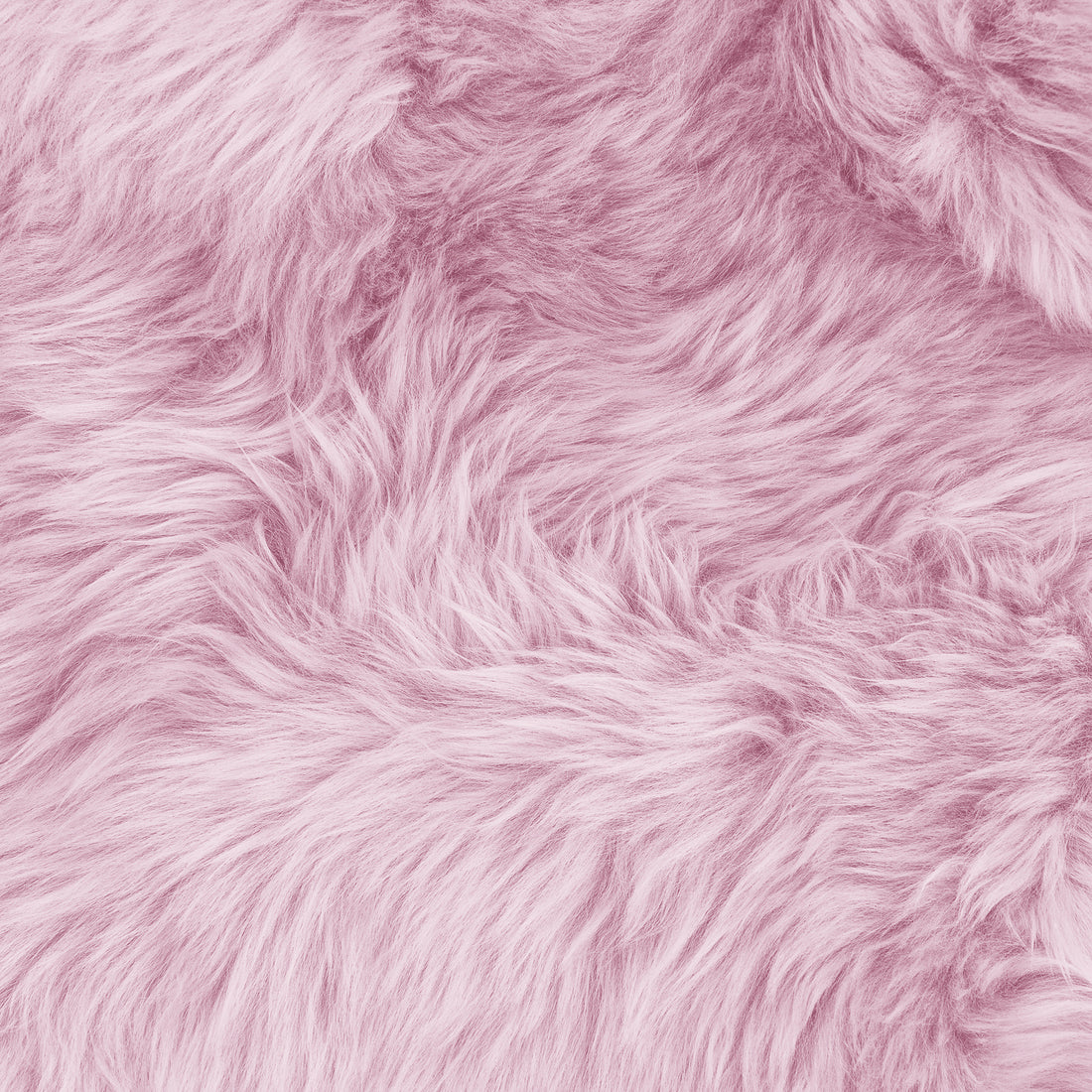 Close-up of the Shaddi Round Shaggy Soft Fluffy Fur Rug in Pink, showcasing its plush, wispy texture resembling faux fur, ideal for adding warmth and luxury to any room.