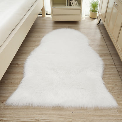 Silvanus 60x90cm Shaggy Soft Fluffy Fur Rug in White, placed centrally on a light wood floor, enhancing the cosy, softly-lit bedroom ambiance with its plush, sheepskin-style texture.