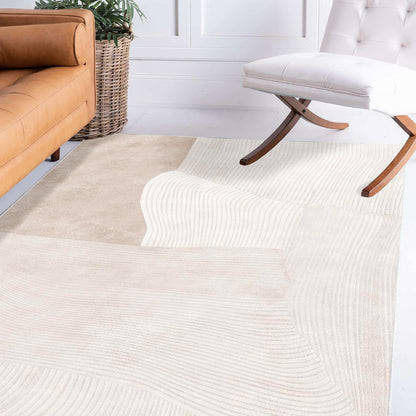 Vastra Modern Abstract Floor Rug 160 x 230cm displayed in a modern living room, showcasing its subtle ribbed patterns in cream and beige, set alongside coordinating caramel-tan leather sofa and white tufted bench.