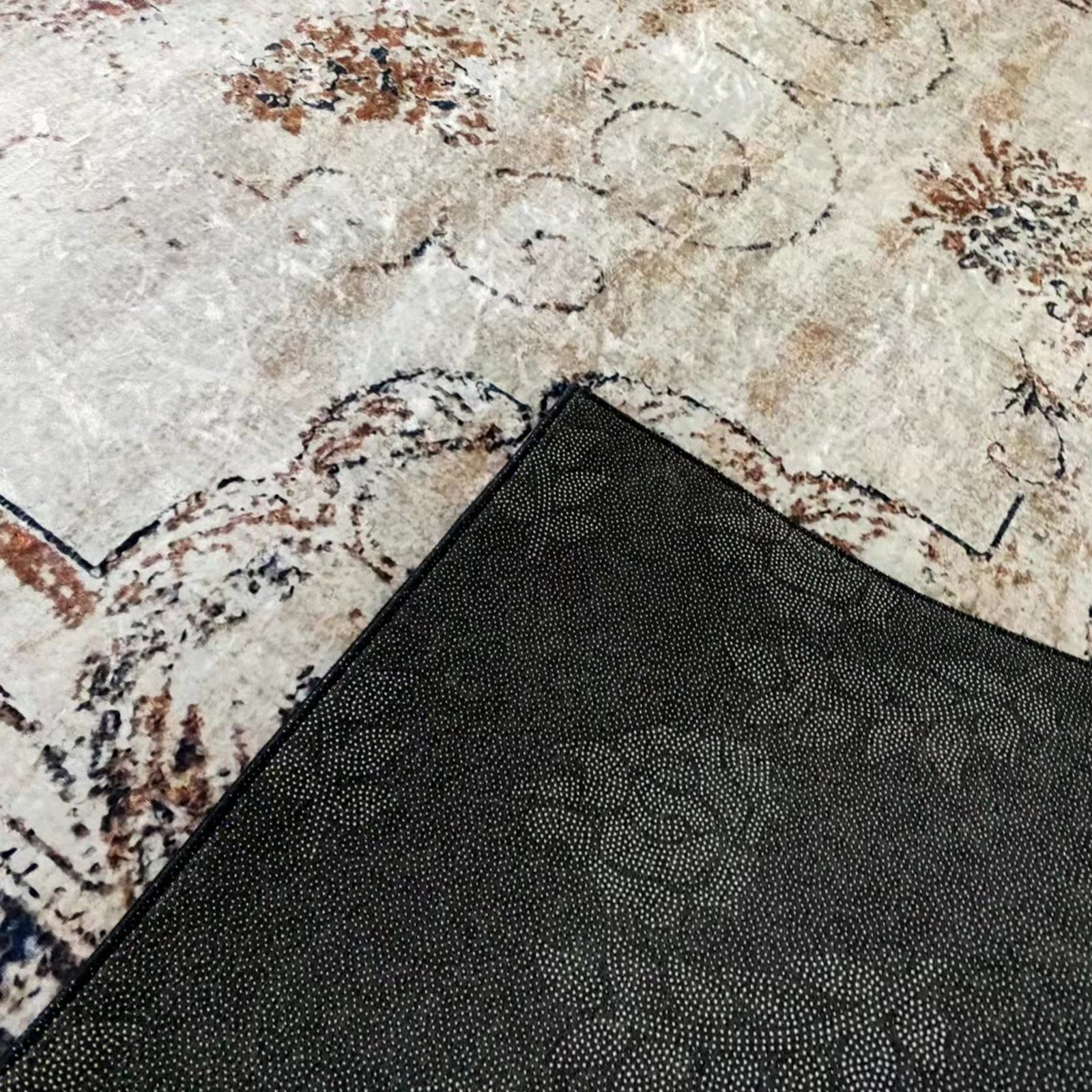 Vikene Distressed Persian Silky Floor Rug, 200 x 300cm, showcasing its light-colored, slightly distressed beige pattern with a black, textured non-slip rug pad underneath for secure placement.