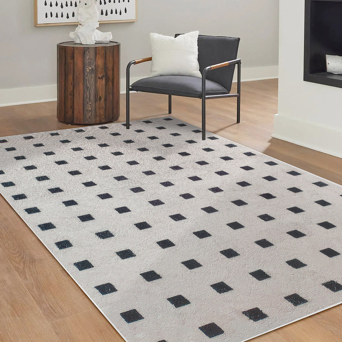 Zabeth 120x180cm Polyester Tufted Modern Abstract Rug with black square pattern on light background, enhancing a hardwood floor in a contemporary setting with minimalist furniture and decor.