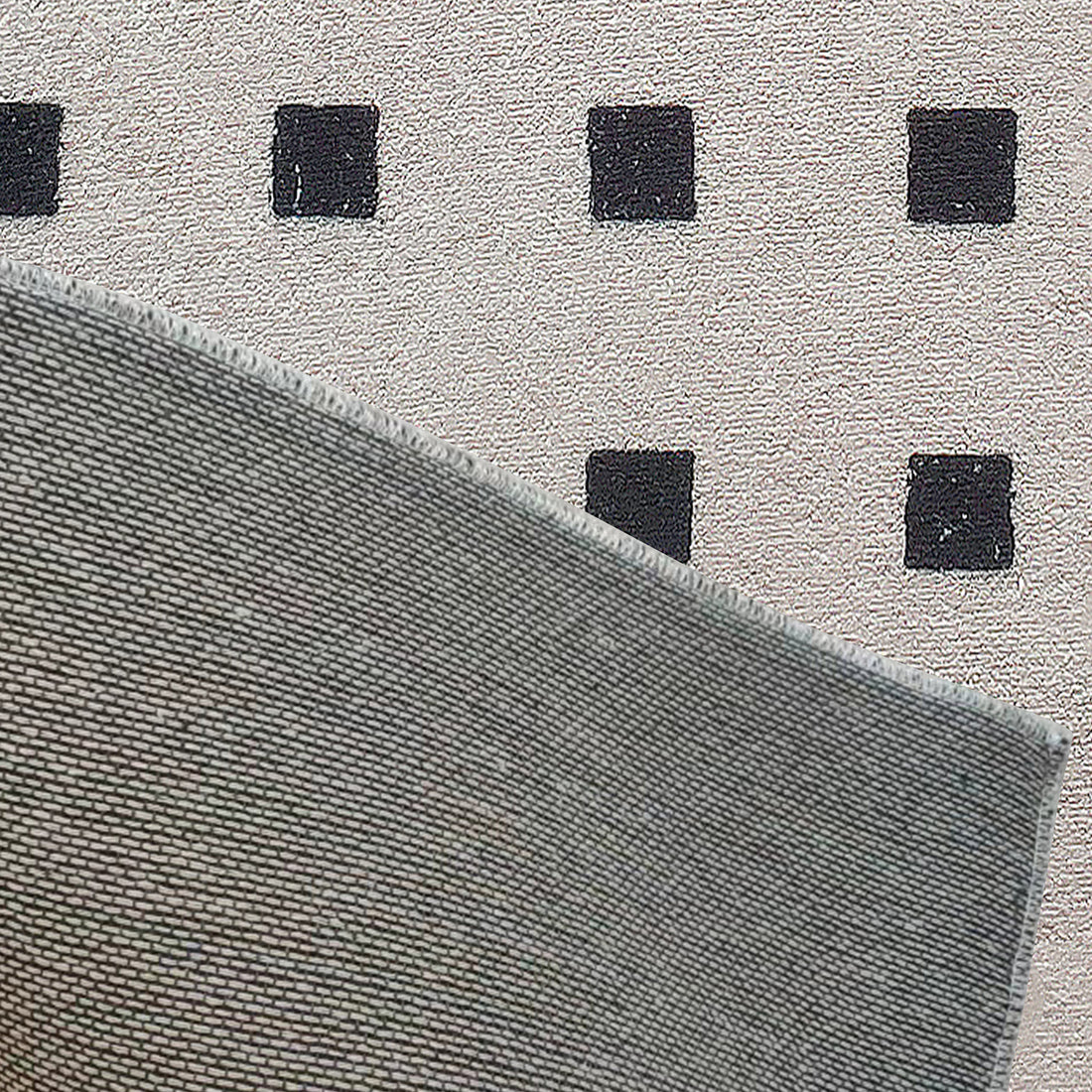 Zabeth 120x180cm Polyester Tufted Modern Abstract Rug draped over an olive-gray woven fabric, showcasing its textured, contemporary design for stylish home interiors.