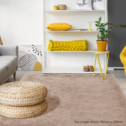 Zubuin 180x230cm Shaggy Plush Rectangular Rug in Beige, showcased in a cozy living room with a woven pouf, yellow accents, and modern furniture, enhancing warmth and style.