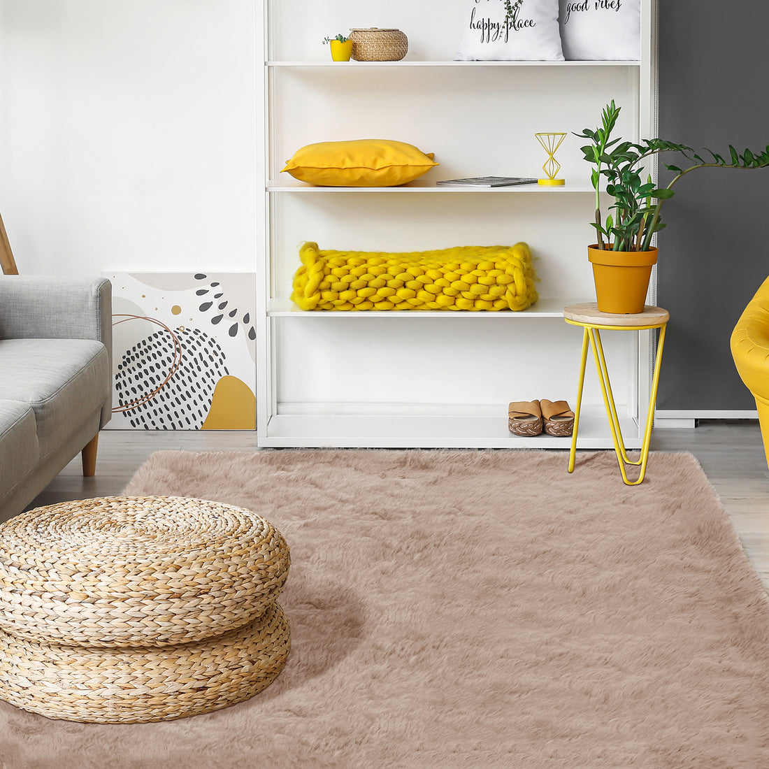 Zubuin 180x300cm Shaggy Plush Rectangular Rug in Beige adorns the floor, exuding luxurious softness. It features a fluffy texture, enhancing the room's cozy ambiance amidst modern decor elements like a seagrass pouf and furniture.