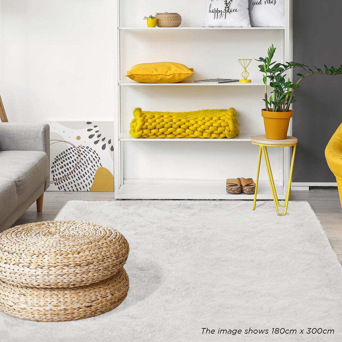 Zubuin Shaggy Plush Fluffy Rectangular Fur Rug - White 90 x 150cm lies elegantly on the floor, complementing the modern decor with its luxurious texture, surrounded by seagrass pouf and minimalist furnishings.