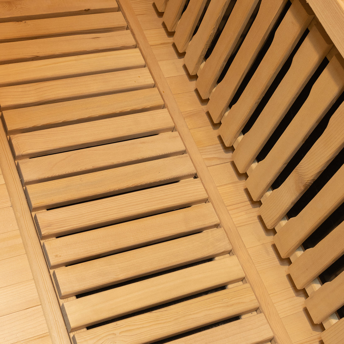 Close-up of Harlow 1 Person Canadian Hemlock Infrared Home Sauna showcasing light-colored wooden slats, indicative of its sleek design, ideal for a soothing indoor sauna experience.