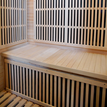 Hirsi 2 Person Carbon Fibre Infrared Indoor Home Sauna interior with light-toned wooden benches and slatted walls, showcasing a spacious design ideal for home relaxation and detoxification.