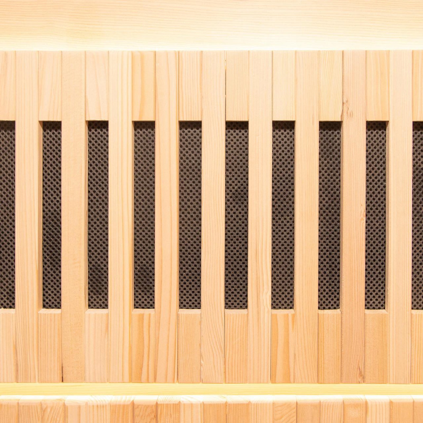 Close-up of Hoito 4-Person Full Spectrum Infrared Sauna with Glass Floor Heaters, featuring light-colored wood vertical slats and dark mesh backing, resembling a decorative grille or speaker-front panel.