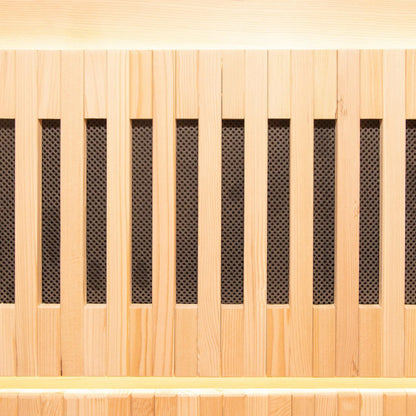 Close-up of Hoito 4-Person Full Spectrum Infrared Sauna with Glass Floor Heaters, featuring light-colored wood vertical slats and dark mesh backing, resembling a decorative grille or speaker-front panel.