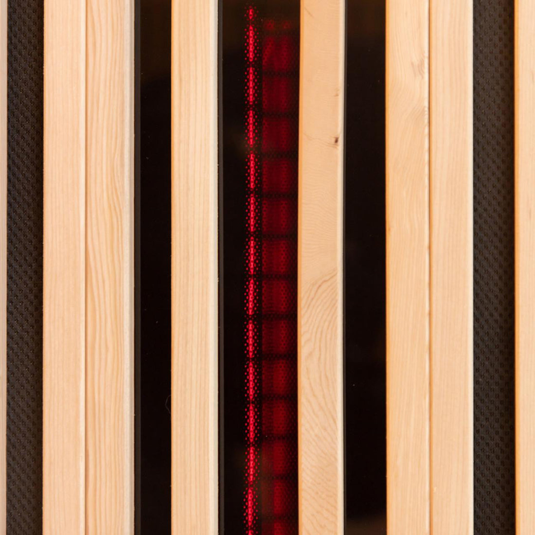 The Hoito 4-Person Full Spectrum Infrared Sauna features vertical pine slats with black inset panels, revealing a red, grid-like glow from the infrared heating element behind protective covers.