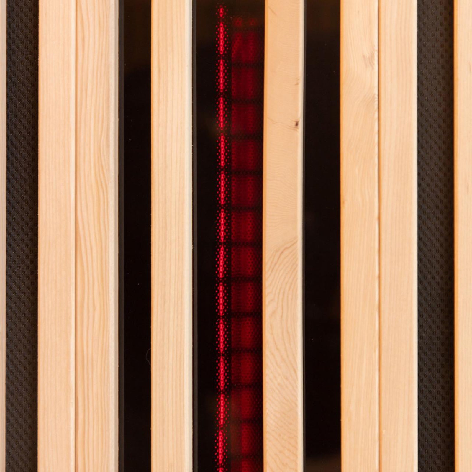 The Hoito 4-Person Full Spectrum Infrared Sauna features vertical pine slats with black inset panels, revealing a red, grid-like glow from the infrared heating element behind protective covers.