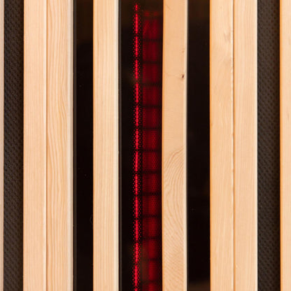The Hoito 4-Person Full Spectrum Infrared Sauna features vertical pine slats with black inset panels, revealing a red, grid-like glow from the infrared heating element behind protective covers.