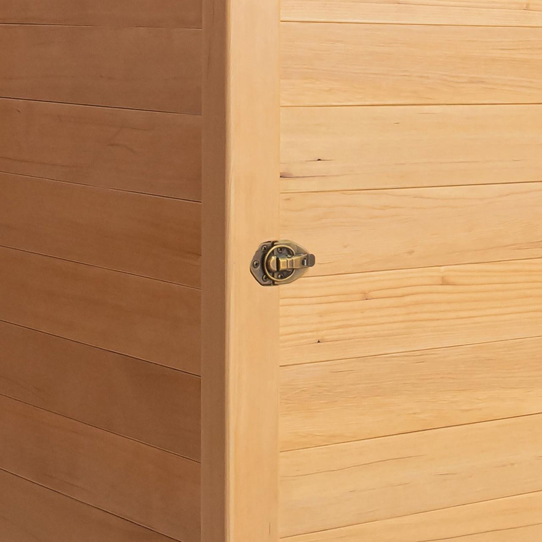 Corner of Hoito 4-Person Full Spectrum Infrared Sauna with Glass Floor Heaters, showing a light-colored wooden panel and a small brass toggle latch, highlighting its quality craftsmanship and secure closure.