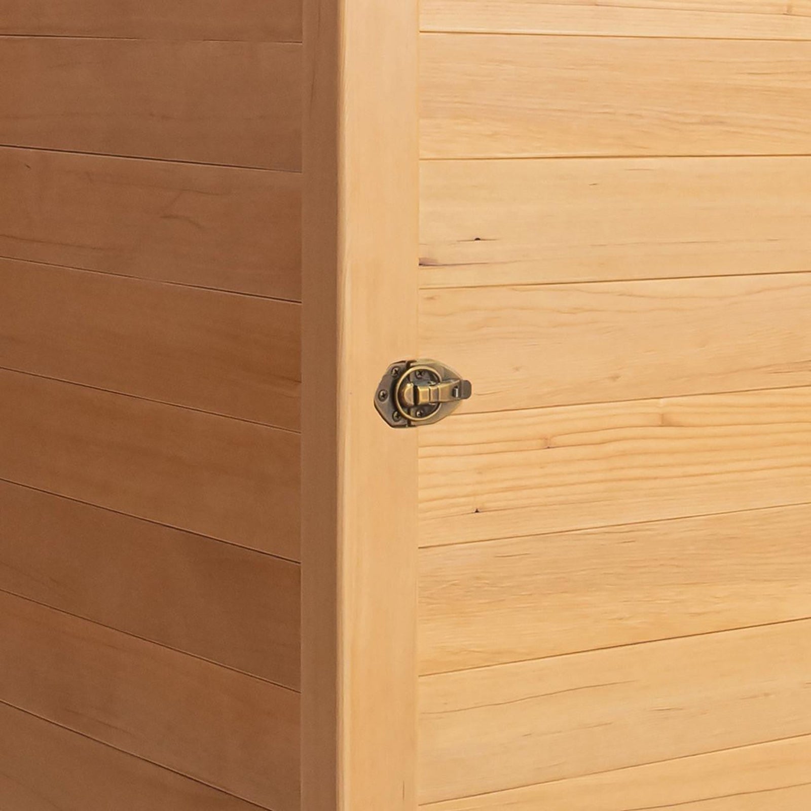 Corner of Hoito 4-Person Full Spectrum Infrared Sauna with Glass Floor Heaters, showing a light-colored wooden panel and a small brass toggle latch, highlighting its quality craftsmanship and secure closure.