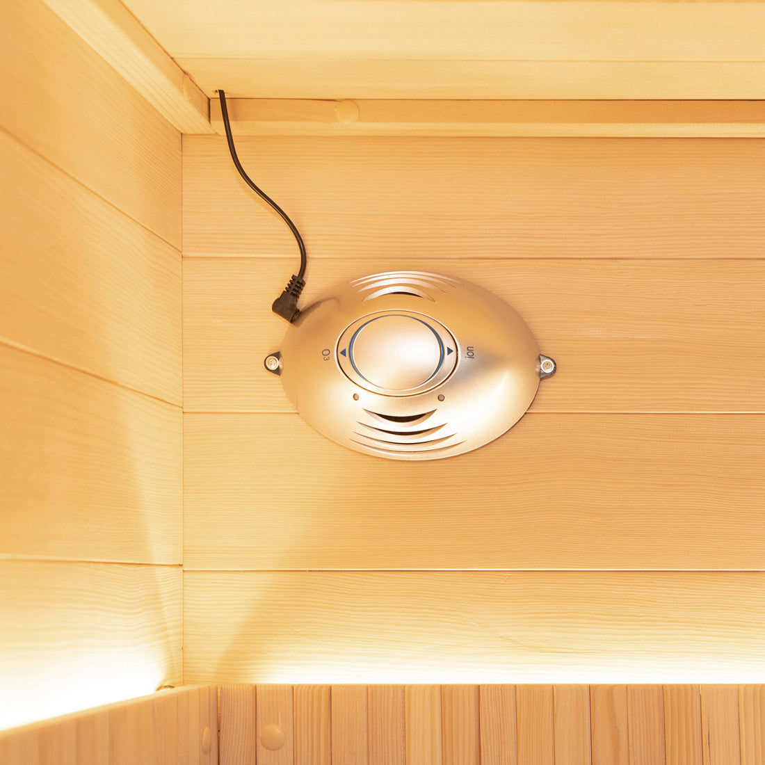 The image shows the Hoito 4-Person Full Spectrum Infrared Sauna with a visible silver O₃/ion generator mounted near the ceiling, enhancing air quality inside the wood-paneled sauna space.