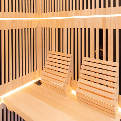 Hoito 4-Person Full Spectrum Infrared Sauna features light-wood slatted walls, benches, adjustable backrests, and soft accent lighting, offering a modern, inviting spa experience with glass floor heaters.