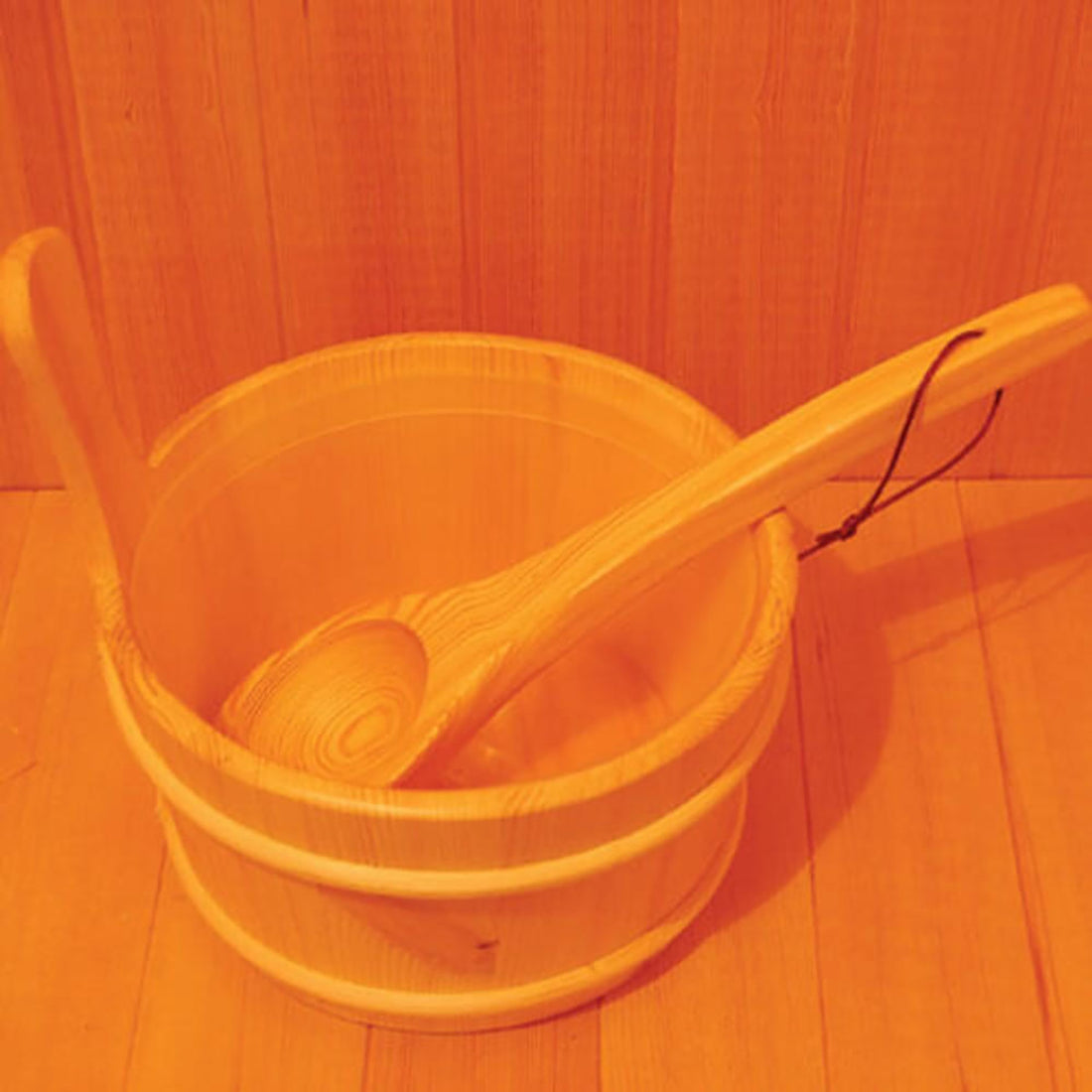 Kivi 3-Person Traditional Stove Finnish Indoor Home Sauna features a small wooden pail with a ladle for pouring water over hot stones, enhancing the authentic sauna experience.