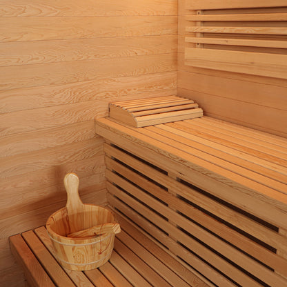 Kivi 4-Person Traditional Finnish Home Sauna interior with slatted wooden benches, wooden walls, and a traditional wooden sauna bucket with ladle, showcasing the spacious and inviting design for relaxation.
