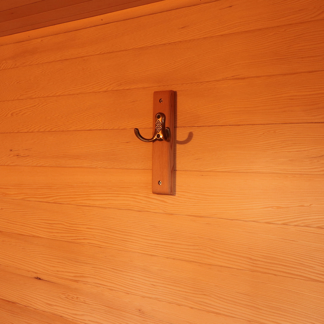 Kivi 4-Person Traditional Finnish Outdoor Sauna featuring a sturdy wooden construction, clear tempered glass doors, and spacious interior visible in close-up, showcasing the craftsmanship of the wood and hardware.