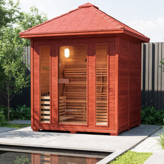 Kivi 4-Person Traditional Finnish Outdoor Home Sauna on a paved patio, featuring a wooden cabin with glass front, visible interior seating, and a discreet LUXO saunas logo on the door.