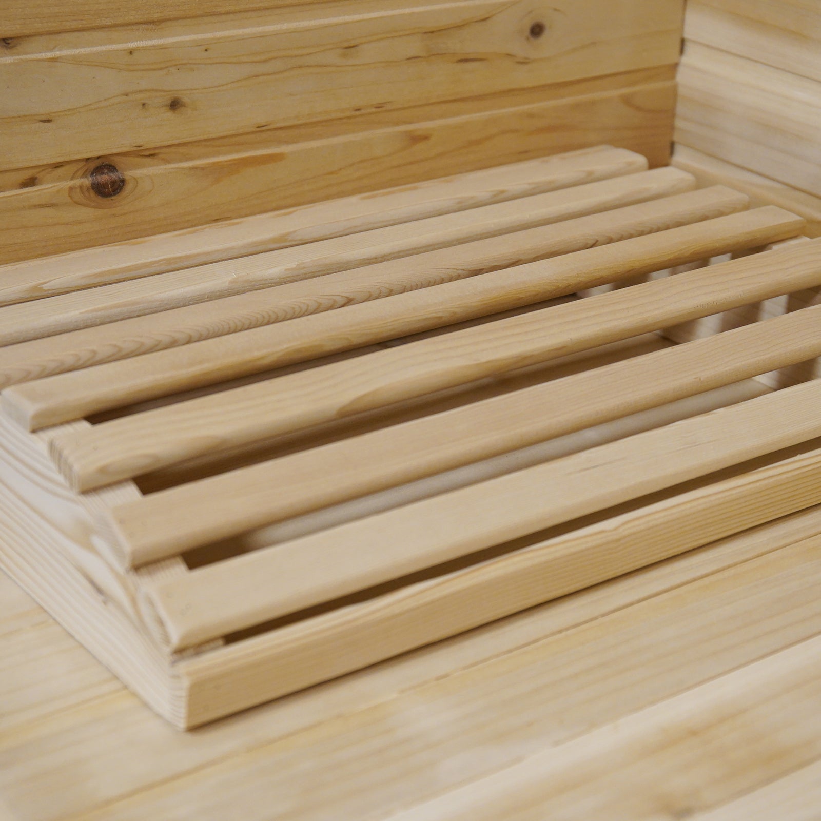 Kivi 4 Person Outdoor Finnish Steam Sauna – Fir Wood, showcasing a wooden bench with slats and close-up of durable fir wood panels, designed for outdoor use and easy assembly.