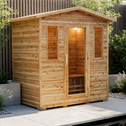 Kivi 4-Person Traditional Outdoor Finnish Home Sauna on a patio, featuring a wooden cabin with glass door, narrow windows, and a simple interior bench, surrounded by greenery.