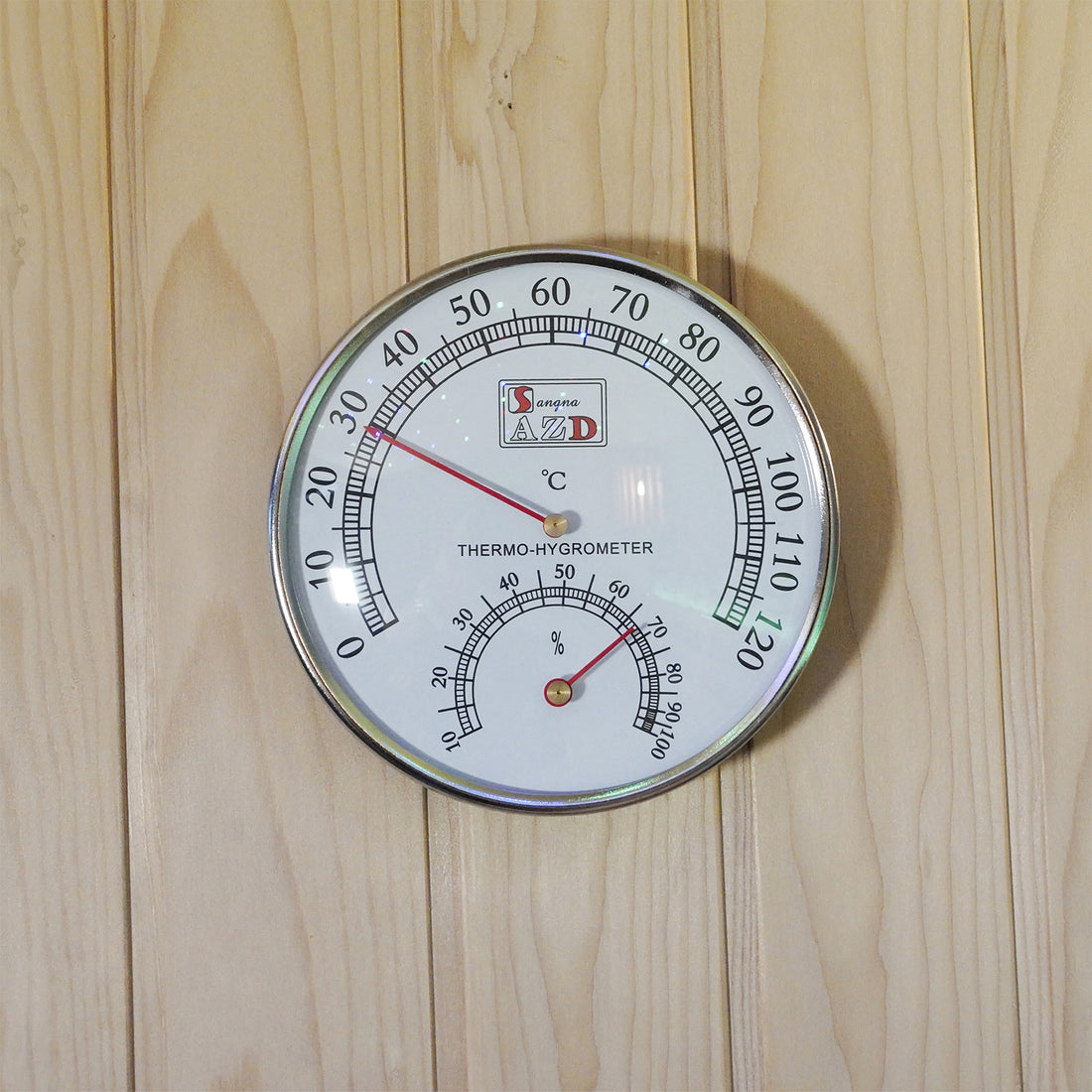 Loyly 3 Person Traditional Finnish Indoor Home Sauna features a chrome-edged white thermo-hygrometer on a light wooden panel, displaying temperature and humidity, enhancing the sauna experience with precise climate monitoring.