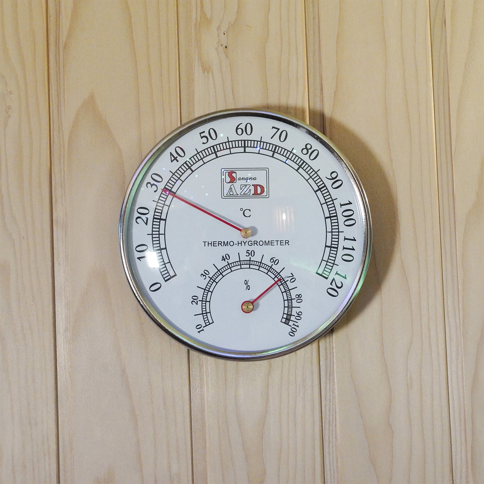 Loyly 3 Person Traditional Finnish Indoor Home Sauna features a chrome-edged white thermo-hygrometer on a light wooden panel, displaying temperature and humidity, enhancing the sauna experience with precise climate monitoring.
