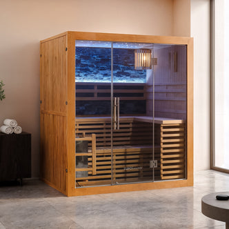 Loyly 3 Person Traditional Finnish Indoor Home Sauna features warm-toned wood, full-height glass doors, tiered benches, a Harvia heater with sauna stones, and LED lighting, creating a spa-like atmosphere.