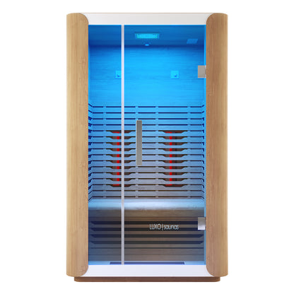 Lue 2 Person Full Spectrum Curved Infrared Indoor Home Sauna with a light-wood frame, full-height glass door, glowing infrared panels, slatted bench, and cool-blue LED lighting, featuring Luxo | saunas branding.