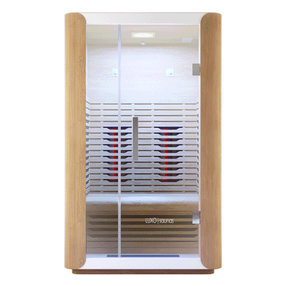 Lue 2 Person Full Spectrum Curved Infrared Indoor Home Sauna with light wood panels, glass door, infrared heaters, LED lighting, bench seating, and stainless steel handle, creating a modern relaxation space.