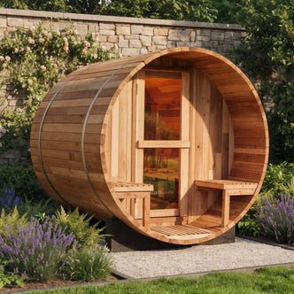 Luola 2 Person Red Cedar Outdoor Barrel Sauna & Harvia Stove in a garden setting, featuring glass-paneled door, built-in bench seats, and metal banding, surrounded by lavender and climbing roses.