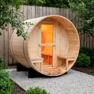Luola 2 Person Pine Outdoor Barrel Sauna & Harvia Stove in a fenced backyard, showcasing a smooth wooden structure with a glass-paneled door, built-in benches, and warm interior lighting.