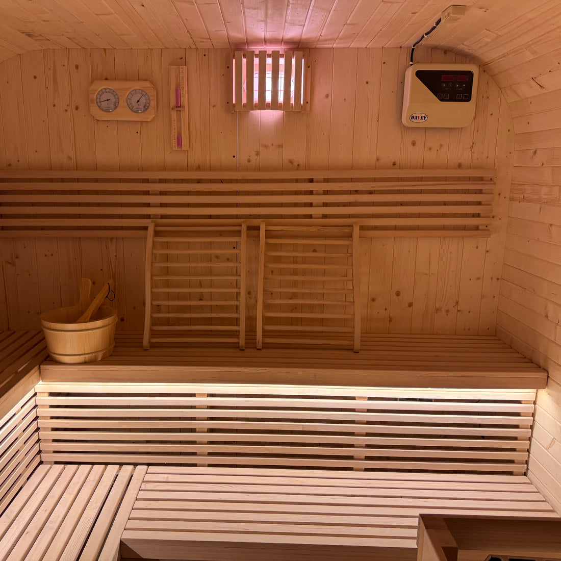 Medika 8 Person Traditional Finnish Outdoor Sauna with a sleek design, featuring a close-up of its vent, wooden ladder against the wall, showcasing its robust construction for an authentic wellness experience.