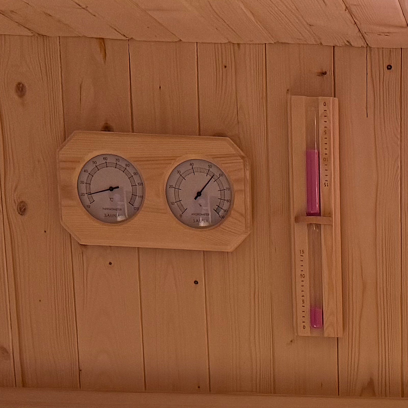 Medika 8 Person Traditional Finnish Outdoor Sauna with a close-up of a thermometer and temperature gauge, featuring durable fir wood and a tempered glass door for a calming wellness retreat.