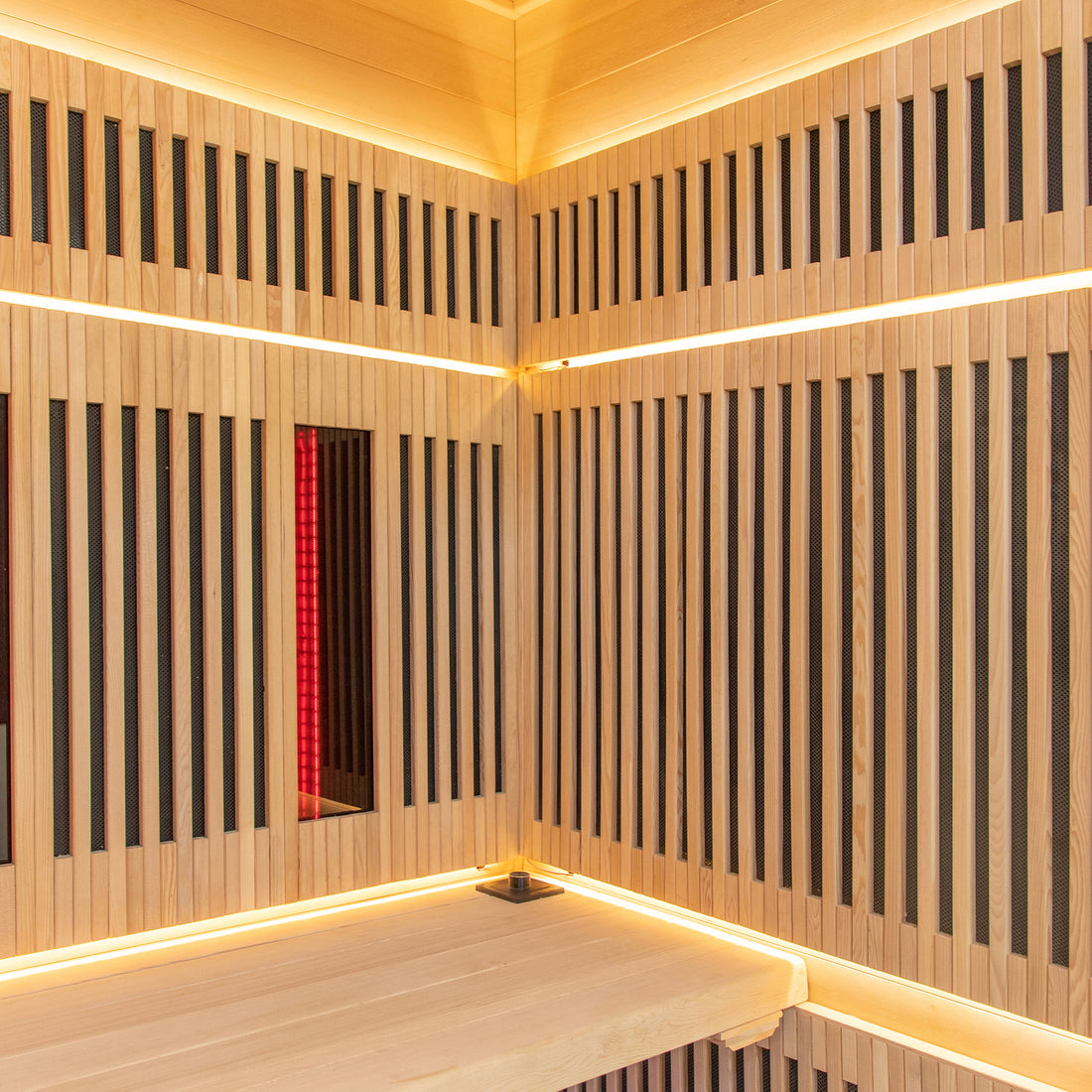 Close-up of Runko 2 Person Canadian Hemlock Carbon Fibre Infrared Sauna, highlighting its sleek wood paneling and interior design, featuring corner details and integrated lighting for a serene indoor experience.