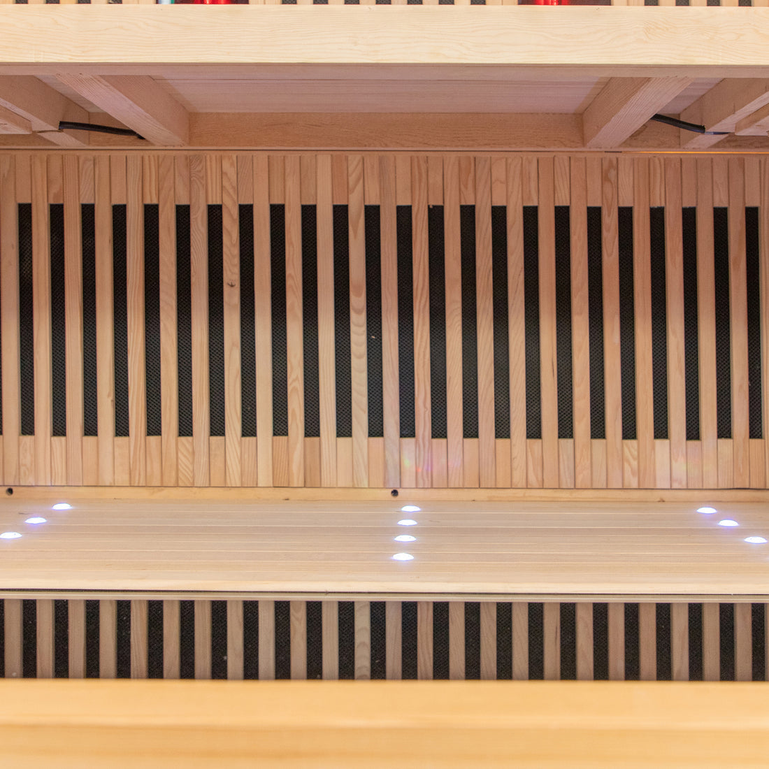 Runko 2 Person Canadian Hemlock Carbon Fibre Infrared Sauna displayed on a smooth wooden surface, highlighting its sleek design and premium materials, ideal for indoor relaxation and wellness.