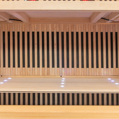 Runko 2 Person Canadian Hemlock Carbon Fibre Infrared Sauna displayed on a smooth wooden surface, highlighting its sleek design and premium materials, ideal for indoor relaxation and wellness.