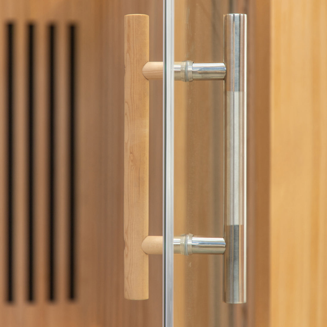 Close-up of the Runko 2 Person Canadian Hemlock Carbon Fibre Infrared Sauna, showcasing the wooden door handle and brown curtain, emphasizing its elegant design and quality craftsmanship.