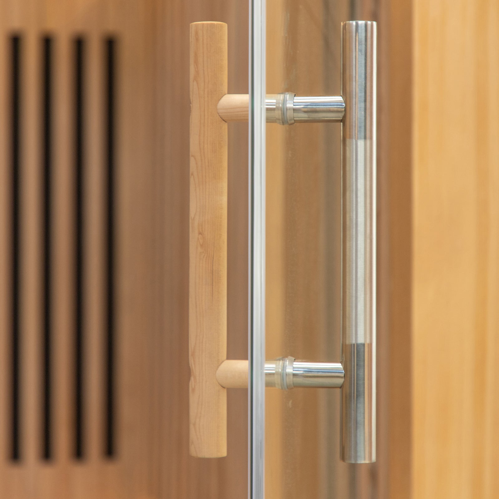Close-up of the Runko 2 Person Canadian Hemlock Carbon Fibre Infrared Sauna, showcasing the wooden door handle and brown curtain, emphasizing its elegant design and quality craftsmanship.