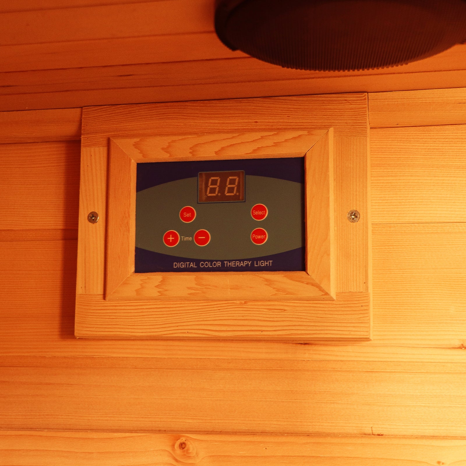 Control panel for the Taavi 4-Person Corner Carbon Fibre Far Infrared Home Sauna, featuring a wood frame, LED display, and buttons for setting digital color therapy lights.