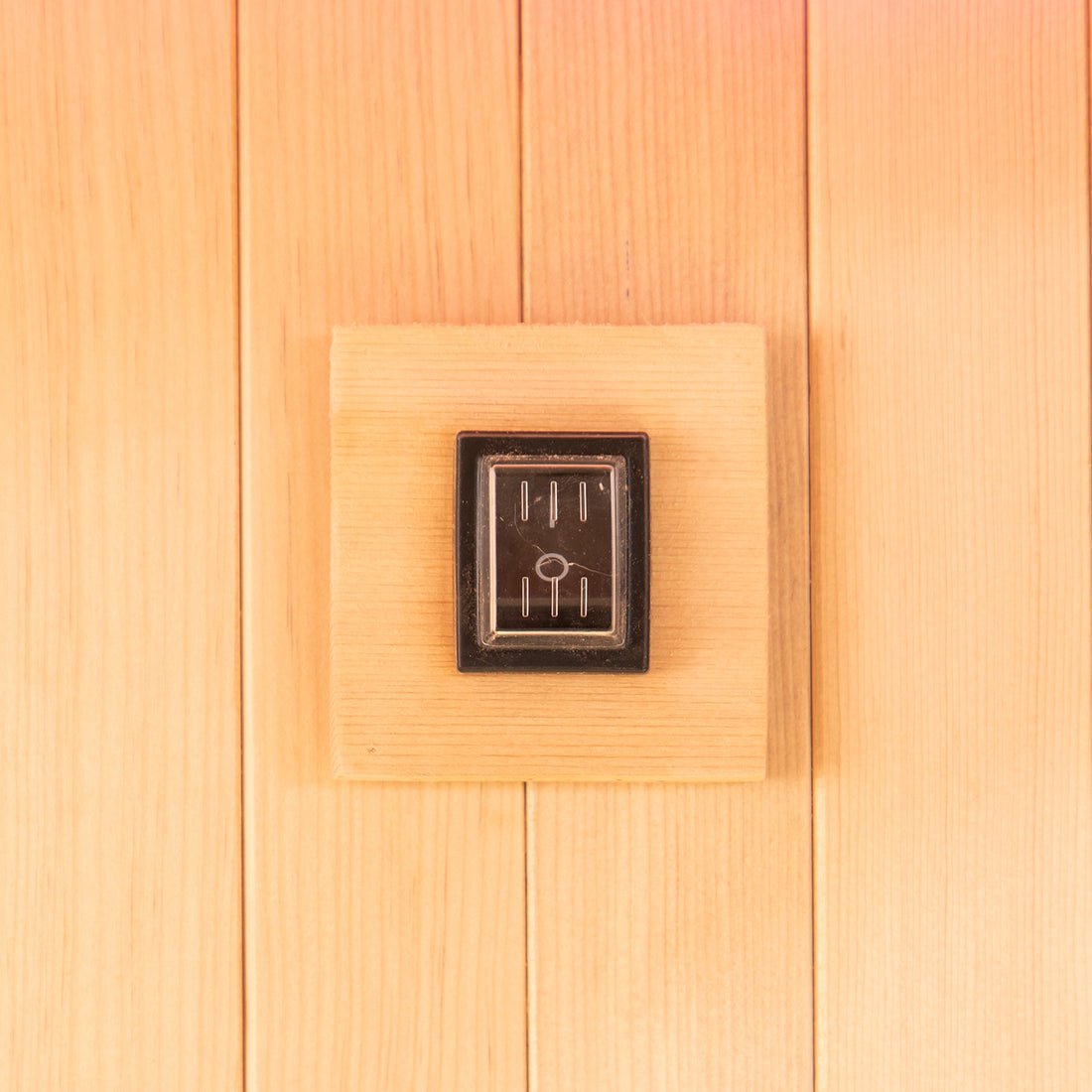 Close-up of the Tarve 3 Person Canadian Hemlock Sauna with Harvia Stove, highlighting the smooth, rectangular wooden surface crafted from premium hardwood, showcasing its elegant, natural finish and sturdy construction.