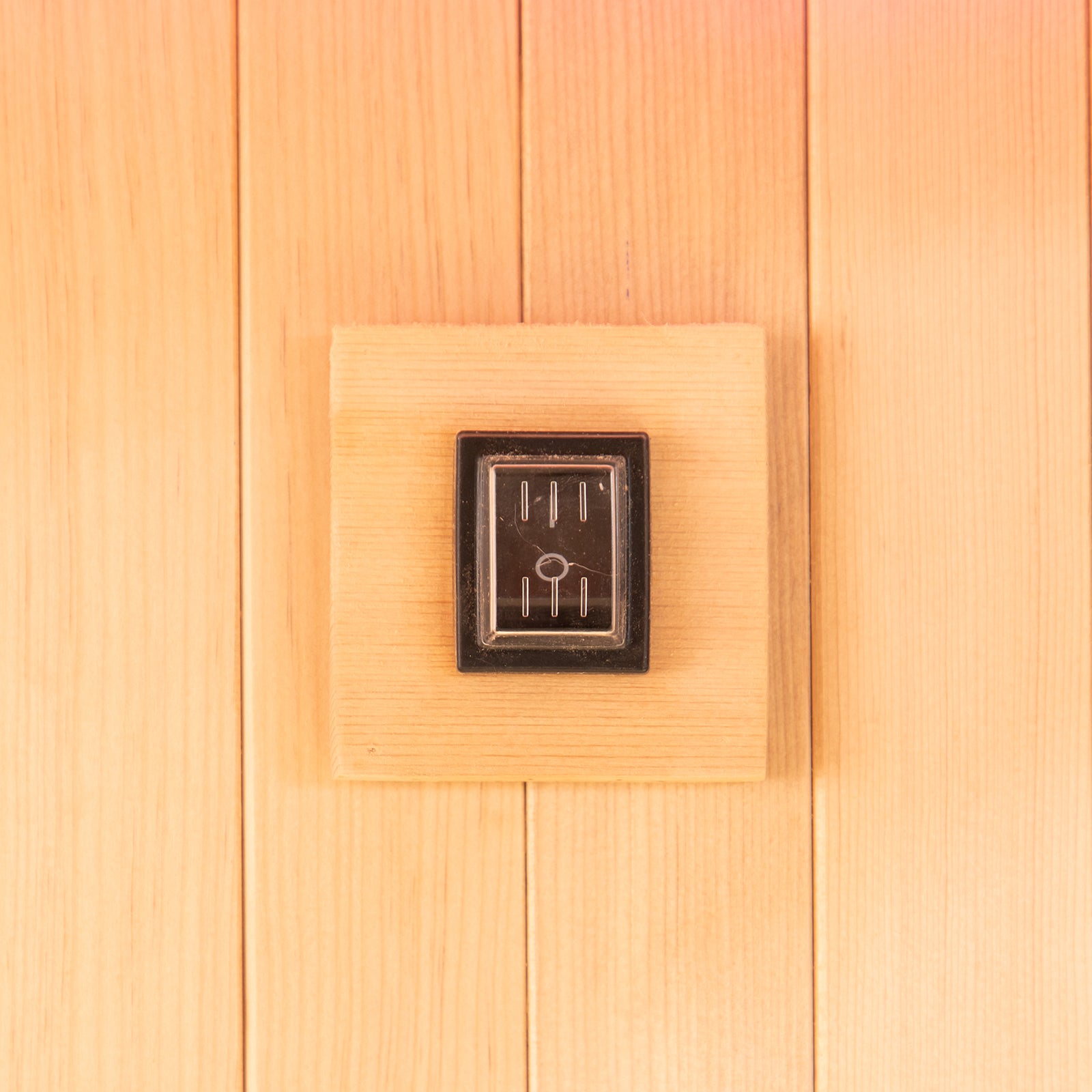 Close-up of the Tarve 3 Person Canadian Hemlock Sauna with Harvia Stove, highlighting the smooth, rectangular wooden surface crafted from premium hardwood, showcasing its elegant, natural finish and sturdy construction.